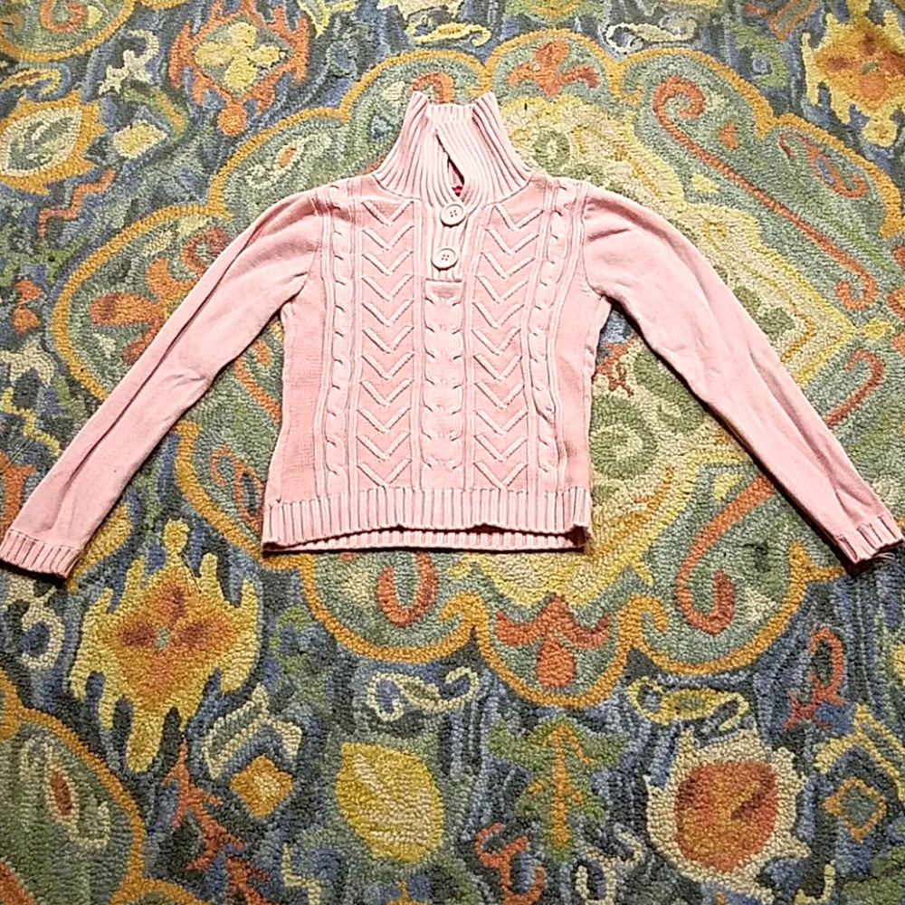 A pink knitted looking sweater